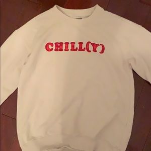 White sweater with the word “chilly” in red